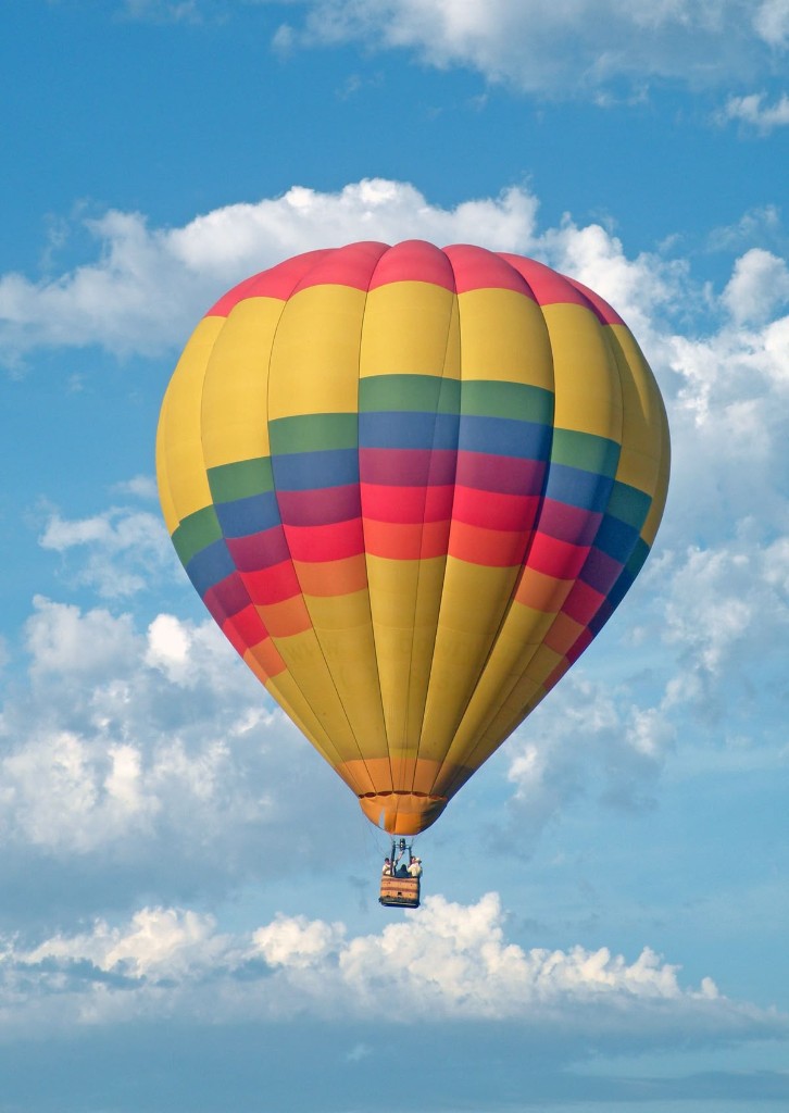 Hot air balloon soaring over Bande Falls and Resort